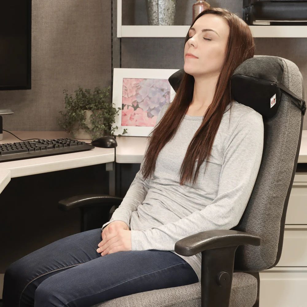 Asian Women Using Neck Pillow and Resting on Office Chair Isolat